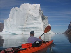 Paddling by iceberg , image by Dan Jones